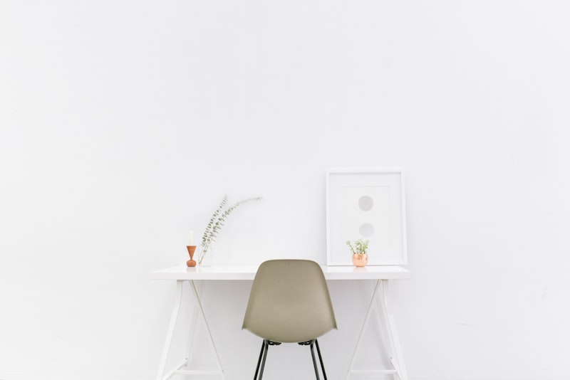 A bright contemporary living space with clean lines, a neutral palette, soft curves, and one sculptural accent