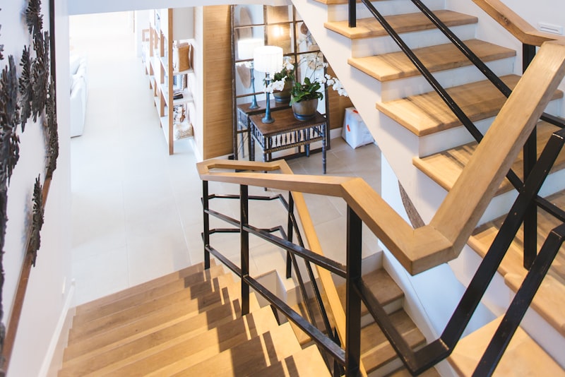 A small room with tall shelving running toward the ceiling, wall-mounted lighting, and a clear floor