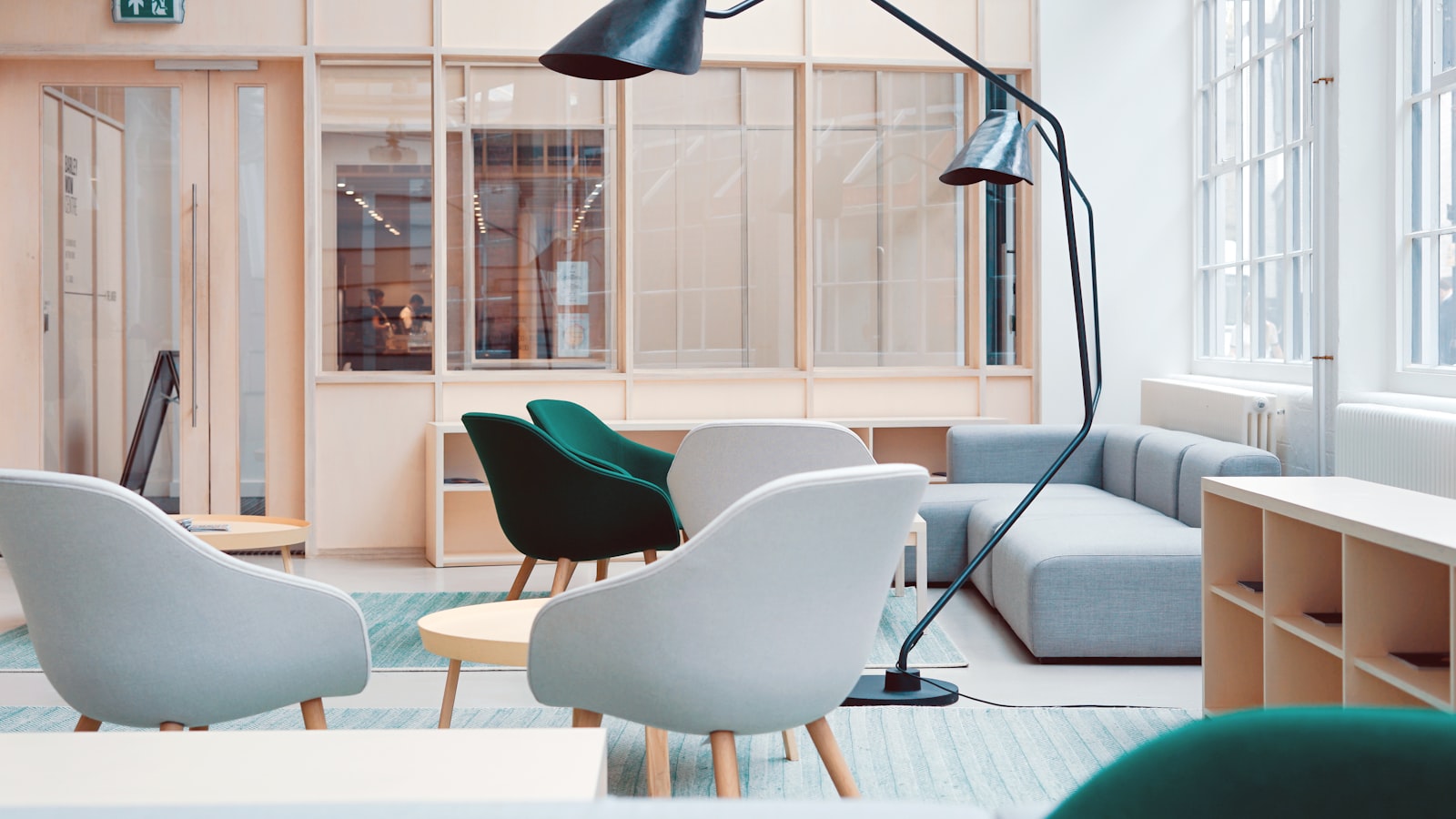 A bright entryway with a slim console, a wall hook rail, a mirror, and a small bench