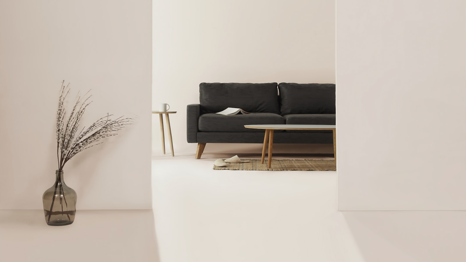 A minimalist living room warmed by wood tones, a chunky knit throw, soft lamplight, and a single trailing plant.