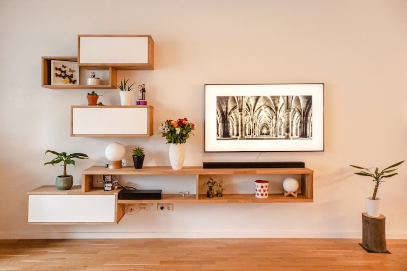Open shelving styled with stacked books, ceramics, a small plant, and intentional open space.