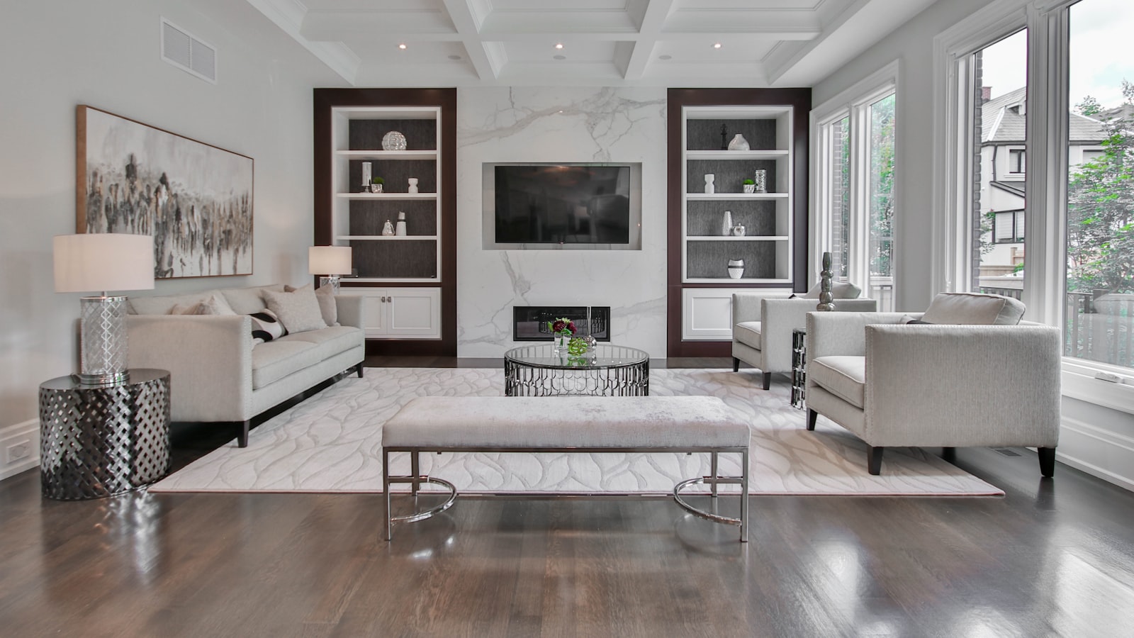 A bold velvet armchair in a rich color serving as a striking focal point in a calm, neutral living room.