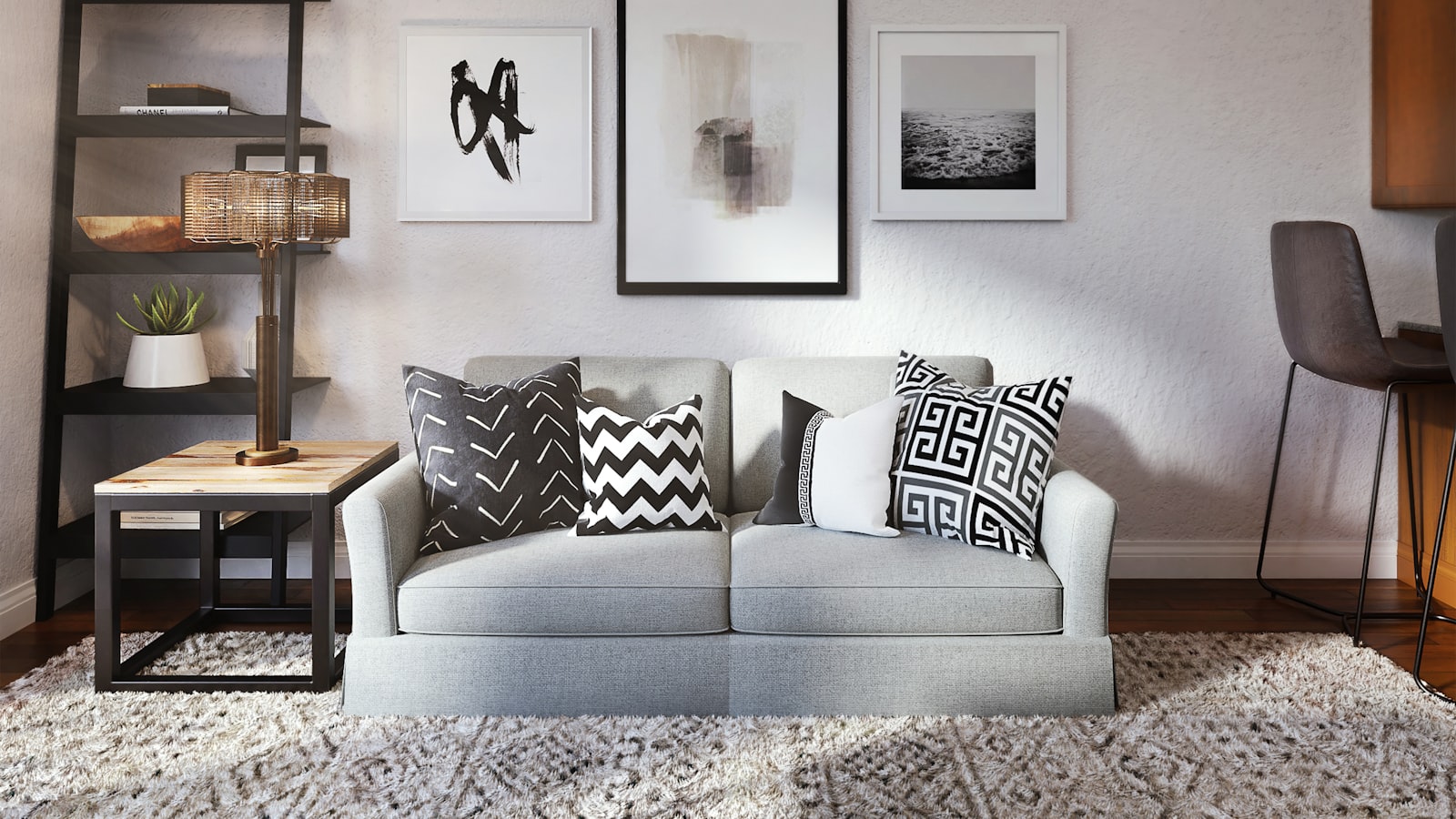 A bright living room with a large round mirror above a console, reflecting daylight from a window opposite.
