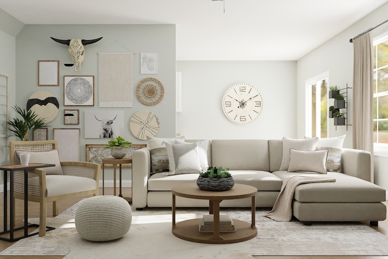 A bright, airy small room with pale walls, a low sofa, a large mirror, and a window letting in soft light