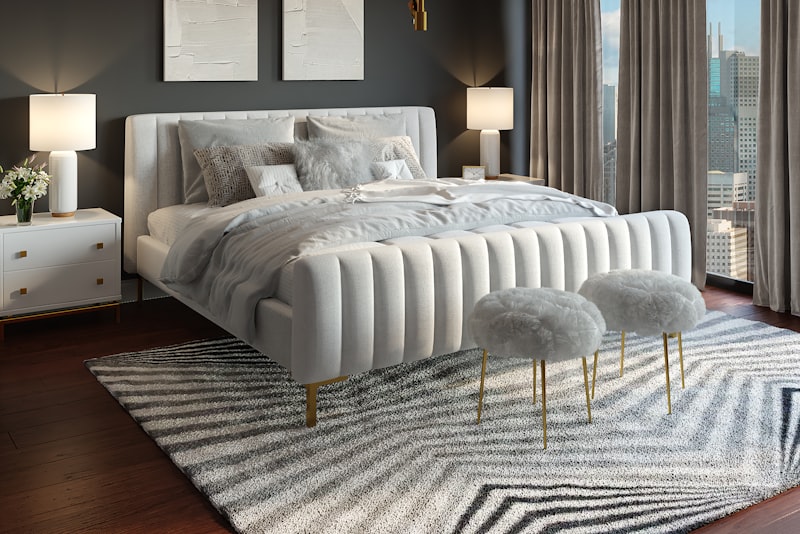 A small but inviting living room with a right-scale sofa, a slim coffee table, soft textiles, and a leafy plant